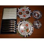 A cased set of six Royal Crown Derby pistol grip tea knives and four various Royal Crown Derby