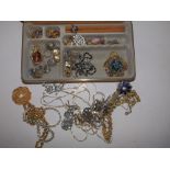 A modern jewellery case & contents necklaces, brooches & other costume jewellery.