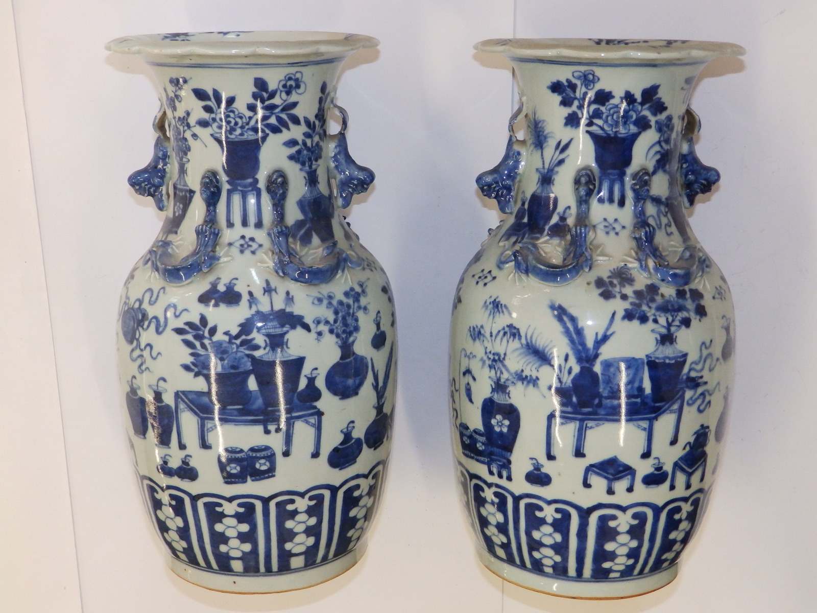 A pair of 19thC Chinese blue & white porcelain vases, the flared rims onto shouldered bodies, each