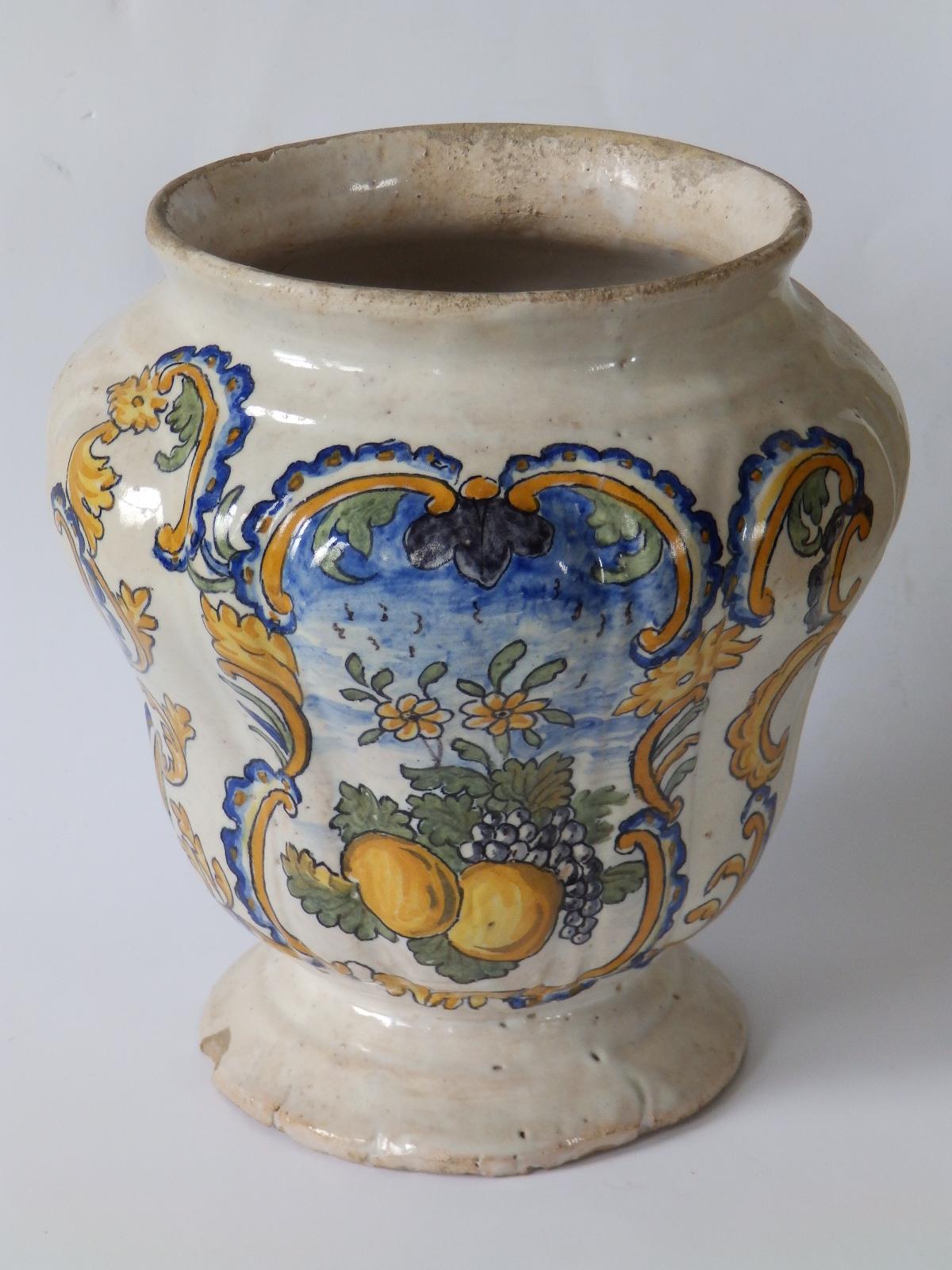 An 18thC continental maiolica jar, probably Italian, decorated with a cartouche depicting a