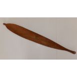 An Austrailan aboriginal wooden woomera spear thrower.