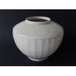 An antique Chinese blanc de chine porcelain vase, of shouldered circular form, moulded overall as