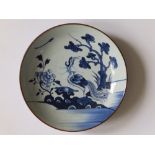 A Chinese blue & white porcelain dish, painted with a large exotic bird in a garden, 10.75"