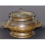 An antique Chinese gilt bronze censer with lion mask handles, the waisted rim having three small