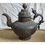 A large Tibetan copper alloy teapot with dragon handle & spout, 12" high.