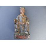 An antique Chinese polychrome carved wood ancestral figure, depicting a seated official decorated in