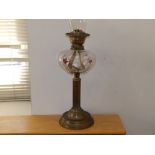 A Victorian oil lamp with moulded & decorated glass reservoir, 17" excluding shade.