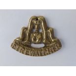 A WWII 'Firewatcher' brass badge of an erotic design, believed to be unofficially cast to make