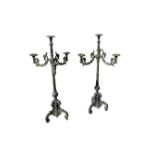 A pair of 19thC cast iron triple-branch floor-standing candelabra in the Baroque taste, 44" high.