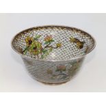 A 19thC Chinese plique a jour bowl, decorated with two birds in flight and flowering shrubs, 5"