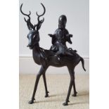 A large Chinese bronze figure group of a wise Immortal seated on a stag, 15.5" high overall.