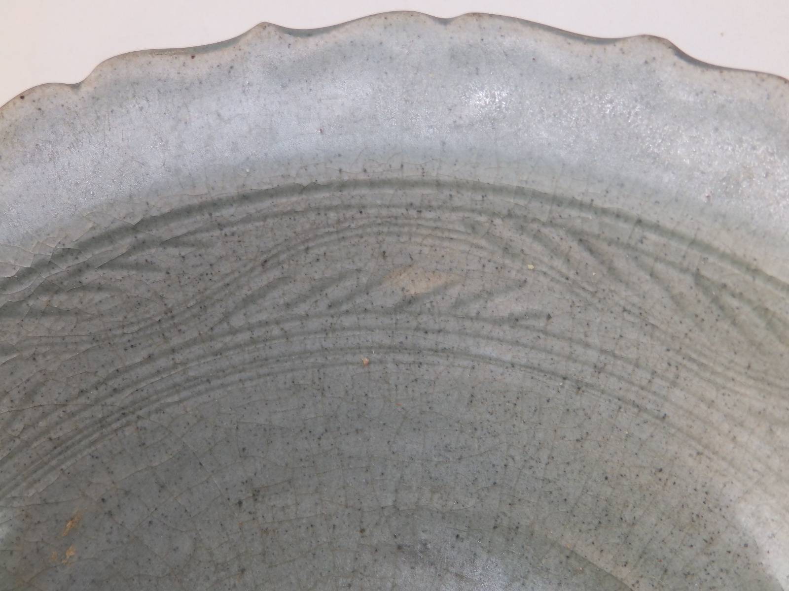 A 15thC Thai celadon glazed stoneware bowl, having lotus leaf moulded rim, a band of incised - Image 2 of 5