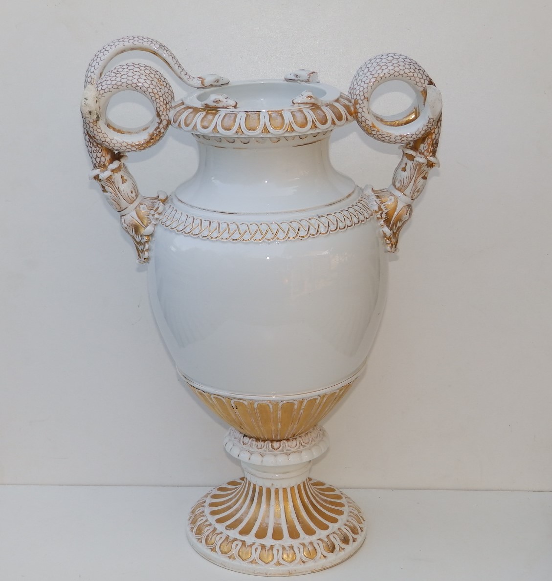 A large 19thC Meissen gilt & white porcelain vase with incomplete serpent handles, 18" high -