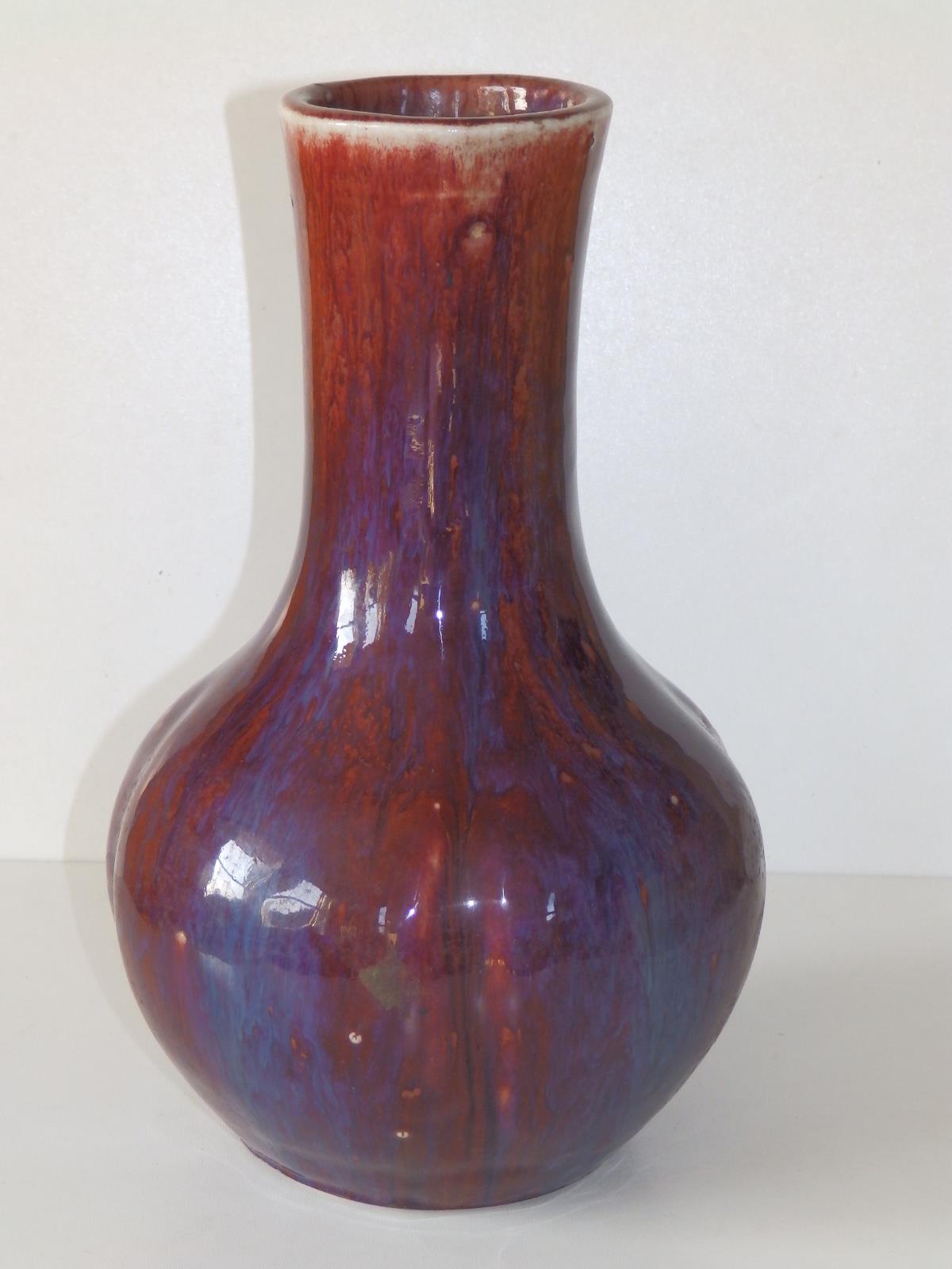 A thickly potted Chinese Sang de Boeuf porcelain bottle vase, decorated in red & purple, the body - Image 2 of 4