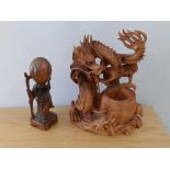 A 20thC Chinese wooden carving of the God of Wisdom , 6" high together with a dragon, 8.25". (2)