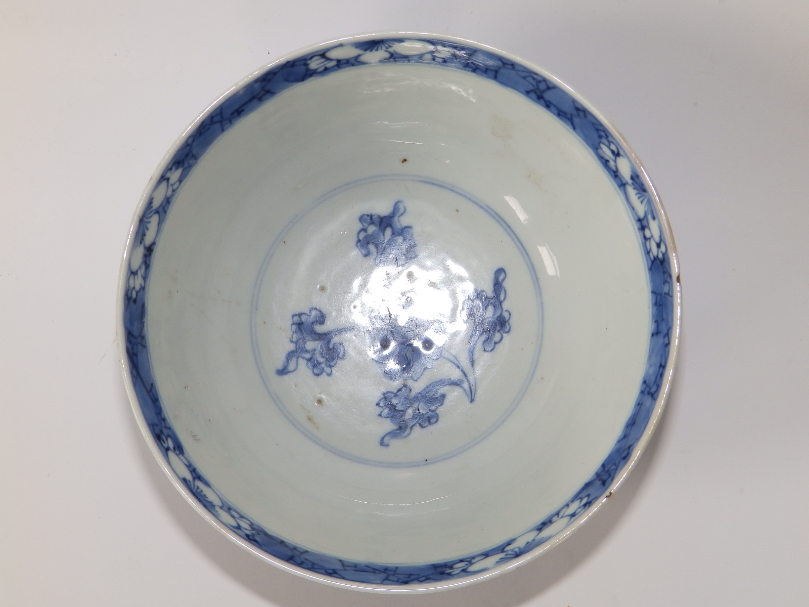 A small antique Chinese blue & white porcelain bowl, decorated with flowering foliage in lappet - Image 2 of 4