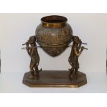 A 19thC Lankan bronze censer being carried by monkeys, the detachable censer of pot-bellied form,