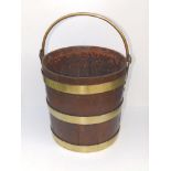 A Georgian brass-bound oak log/peat bucket with swing handle, 11.5" diameter - one brass band