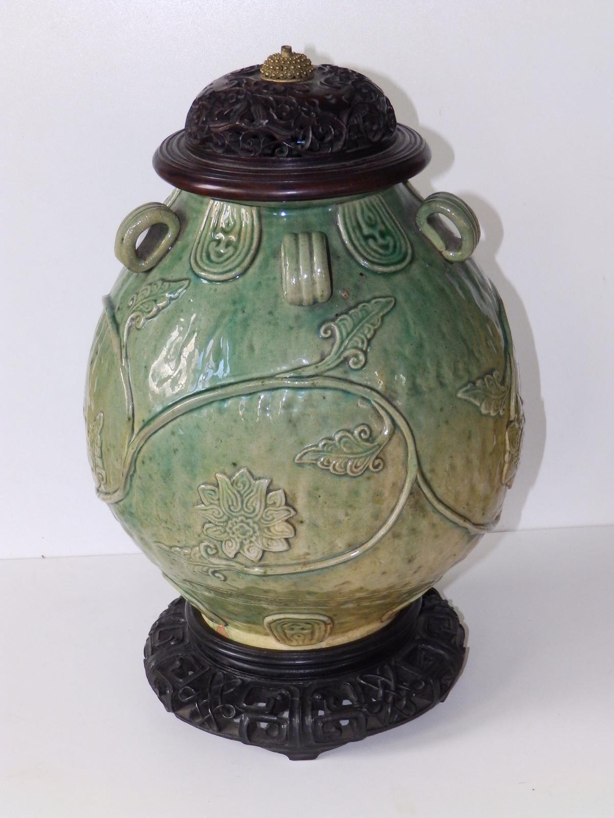 A Chinese provincial celadon glazed jar, of rounded form with five small loop handles, applied