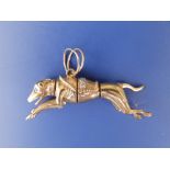 A yellow metal articulated greyhound pendant, 2.4" - tests as 9ct.