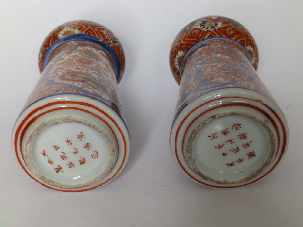 A small pair of Imari porcelain vases, of tapering shape with bulbous necks, three rows of script to - Image 3 of 4