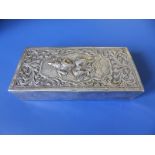 An antique Indian silver box, the hinged cover with embossed decoration depicting a male figure