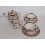 Six pieces of dolls' Victorian tea china decorated in pink lustre flowers, comprising a teapot,