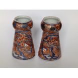 A small pair of Imari porcelain vases, of tapering shape with bulbous necks, three rows of script to
