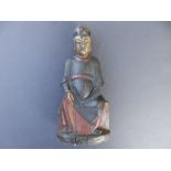 An antique Chinese polychrome carved wood ancestral figure, depicting a seated official in dark robe