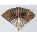 An 18thC French painted ivory & silk fan, the leaf painted with landscape scene showing a courting