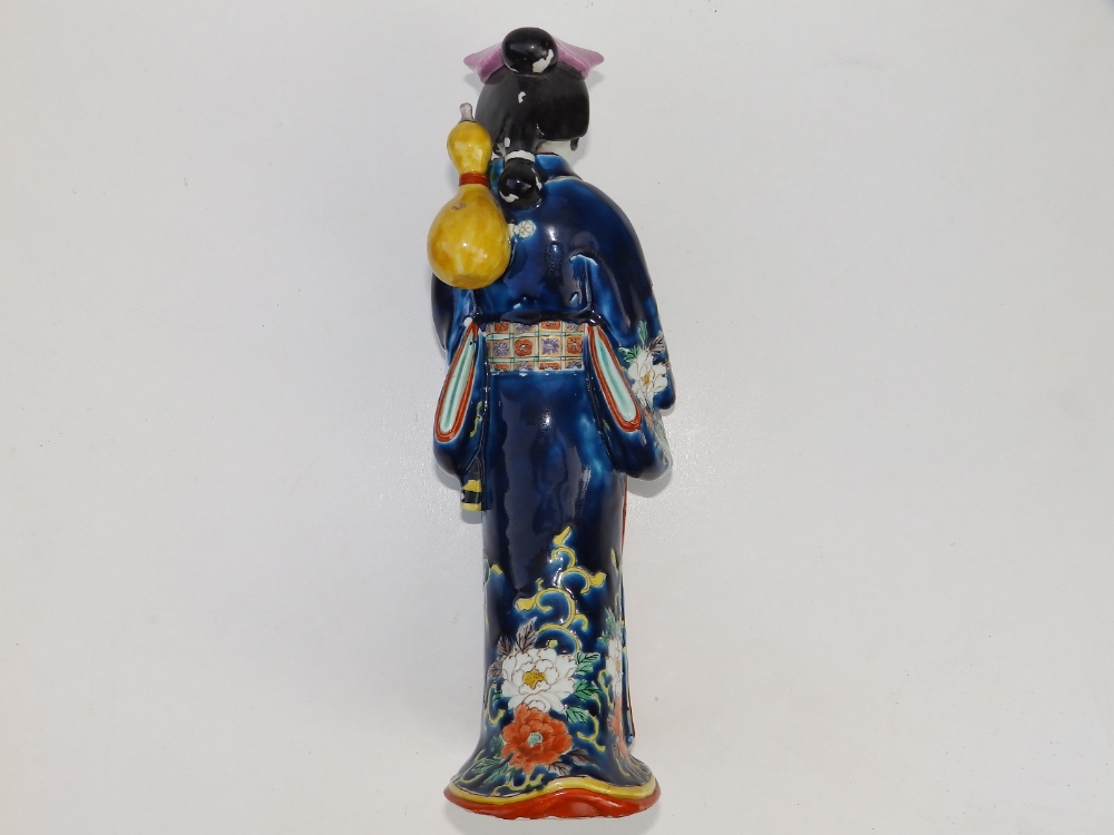 A 19thC Japanese porcelain figure of a bijin, carrying a yellow gourd over her shoulder, 11.75" - Image 2 of 3