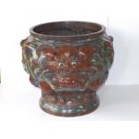 A Chinese Qing Dynasty enamelled bronze jardiniere, boldly cast with the projecting features of