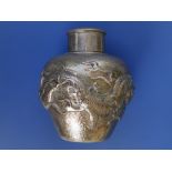 A late 19thC Chinese silver tea caddy with cover, of round shouldered form, the embossed