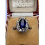 An Edwardian certified 3.7 carat Sri-Lankan sapphire & diamond oval cluster ring, the claw set