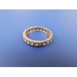 A spinel set yellow metal eternity ring. Finger size P.