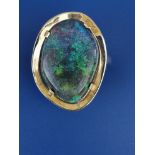 A black opal 18ct gold ring to match the previous lot, the opal 21 x 14mm. Finger size K/L.