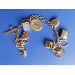 A 9ct gold charm bracelet with 11 charms.