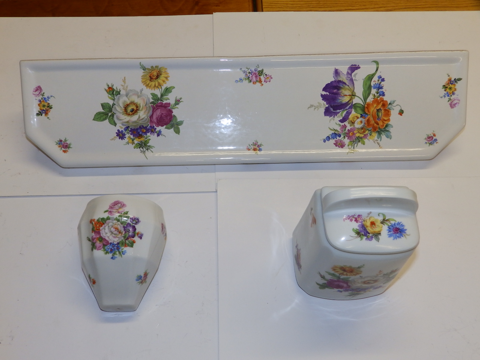 A Limoges porcelain bathroom shelf printed in coloured flowers on white, 23.5" across, together with