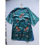 An early 20thC Chinese turquoise silk embroidered robe, worked with colourful flowers.