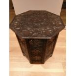 A 19thC Eastern carved octagonal table, 25" across.