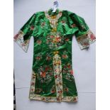 A Chinese green silk robe with floral embroidery.