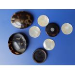 A tortoiseshell circular counter box with mother-of-pearl counters and a pill box. (2)