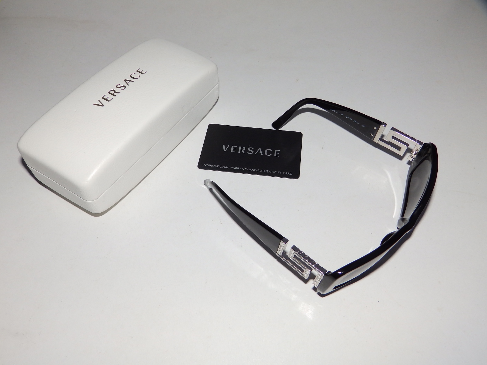 A cased pair of Versace sunglasses - Model 4111-B.