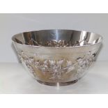 A late Victorian silver fruit bowl, of tapering circular form, repousse decoration of bold floral