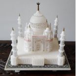 An alabaster model of the Taj Mahal, having coloured details, 7.5" high.