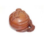 A Chinese carved hardwood box in the form of a peach with detachable lid, impressed numerals to