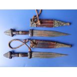A small pair of African daggers with leather hilts & sheaths, 11" overall.