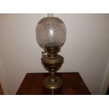 A Victorian brass oil lamp with shade, 19" high overall.