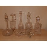 Four various decanter, a ewer and six stoppers.