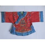 A Chinese child's red silk robe embroidered with a five-clawed dragon, together with an Ottoman